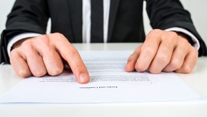 Closeup of a lawyer or a real estate agent proofreading Terms and conditions document.